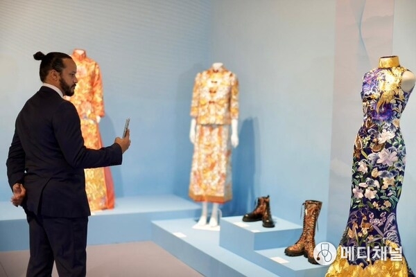 Visitors taking photos at the Chinese fashion section