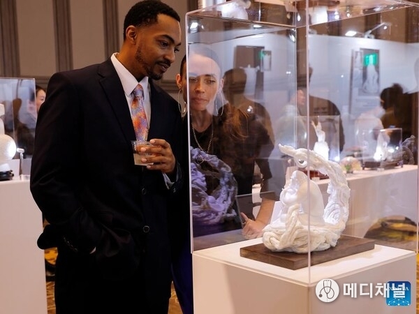 Visitors view an artwork at an exhibition showcasing China